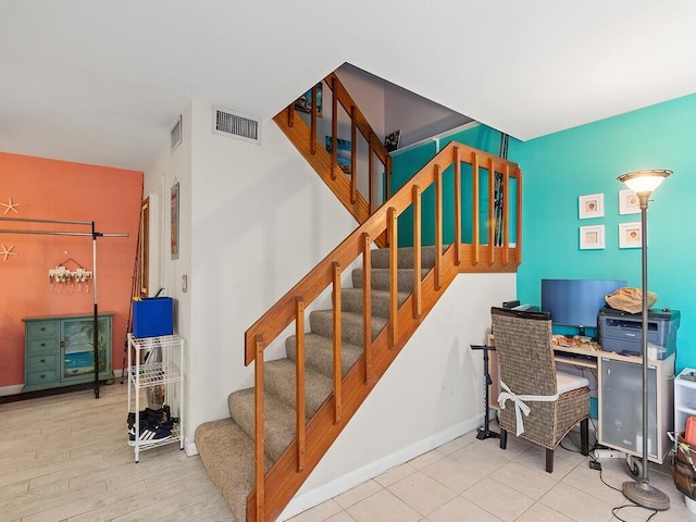 stairway with hardwood / wood-style flooring