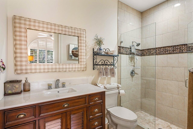 bathroom with vanity, a shower with door, and toilet