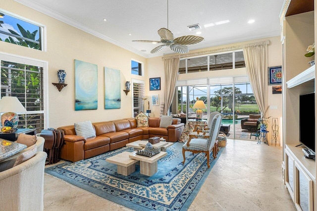 living room featuring crown molding, ceiling fan, and a towering ceiling