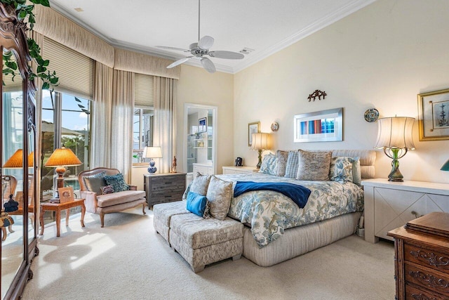 bedroom featuring crown molding, connected bathroom, light colored carpet, and ceiling fan