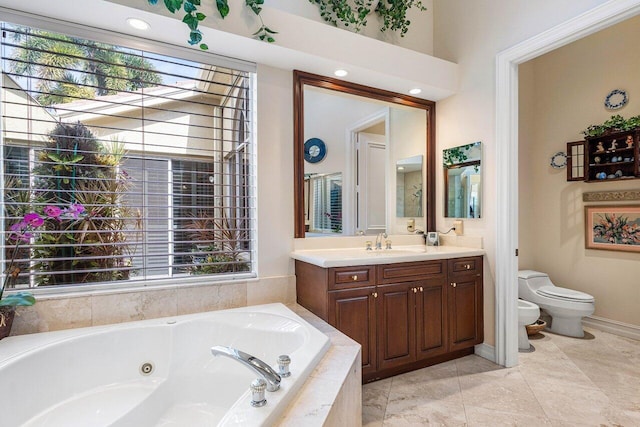 bathroom featuring a relaxing tiled tub, a bidet, vanity, and toilet