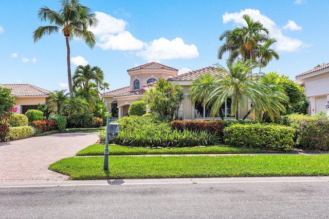 mediterranean / spanish-style home featuring a front lawn