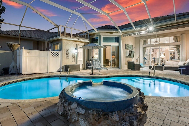 view of swimming pool with an in ground hot tub, an outdoor hangout area, glass enclosure, and a patio area