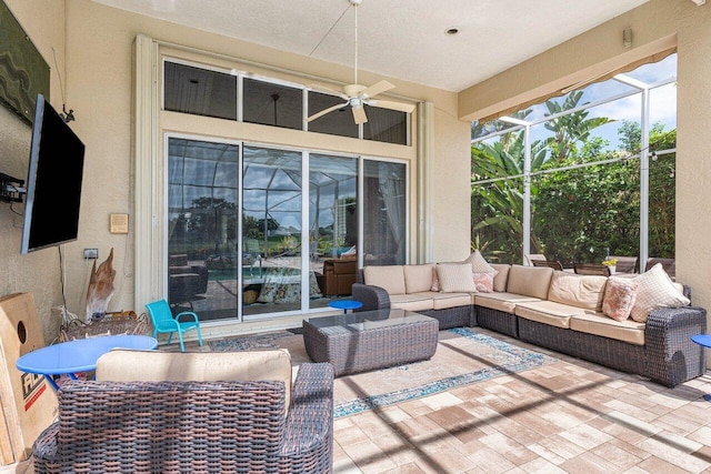 view of patio / terrace with a lanai, outdoor lounge area, and ceiling fan