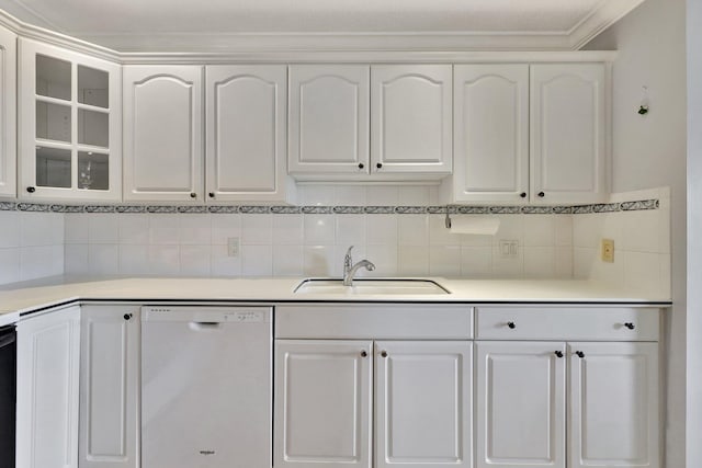 kitchen featuring dishwasher, tasteful backsplash, sink, and white cabinetry