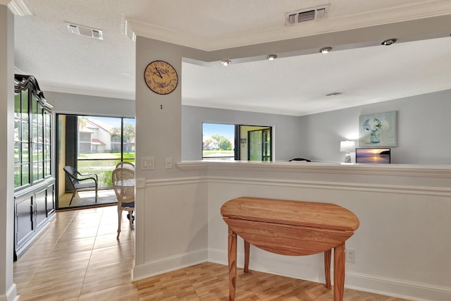 interior space featuring a textured ceiling and crown molding