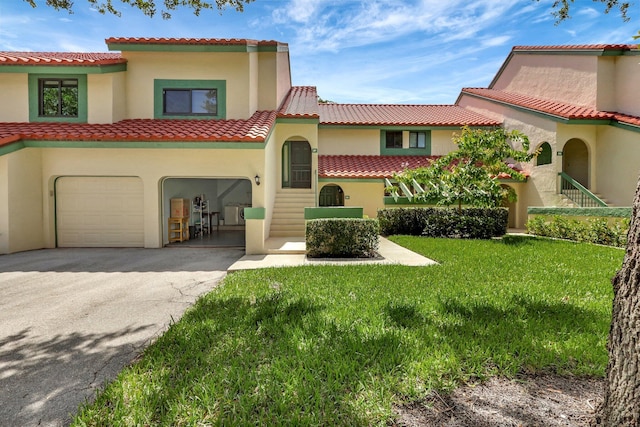 mediterranean / spanish home featuring a garage and a front lawn