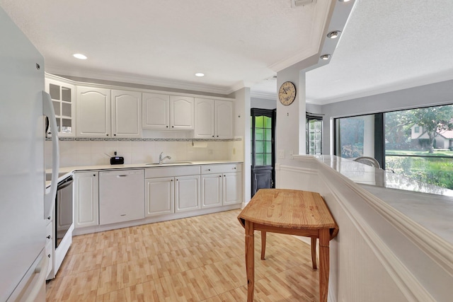 kitchen featuring ornamental molding, tasteful backsplash, white appliances, and plenty of natural light