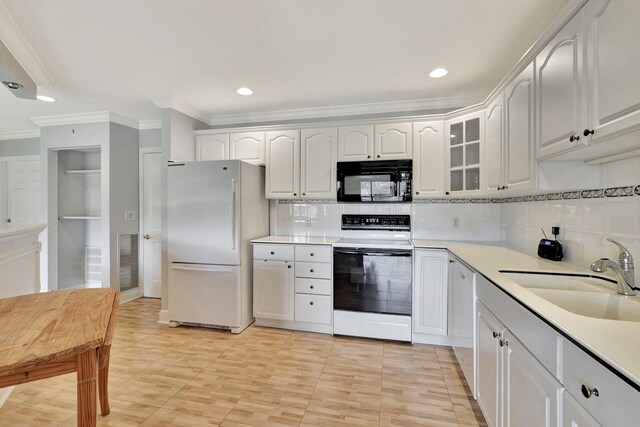 kitchen featuring white cabinetry, backsplash, ornamental molding, white appliances, and sink