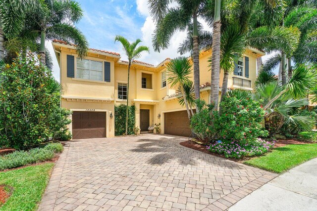 mediterranean / spanish-style home with a garage