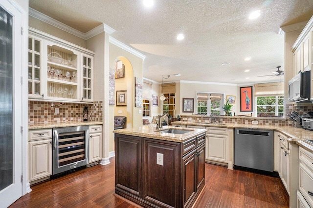 kitchen featuring sink, wine cooler, light stone counters, stainless steel dishwasher, and kitchen peninsula