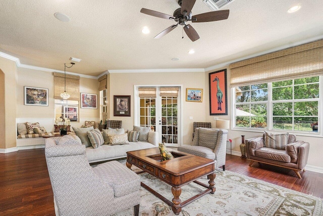 living room with crown molding, dark wood-type flooring, a textured ceiling, and french doors