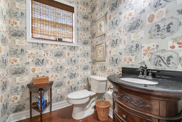 bathroom with vanity, toilet, and wood-type flooring