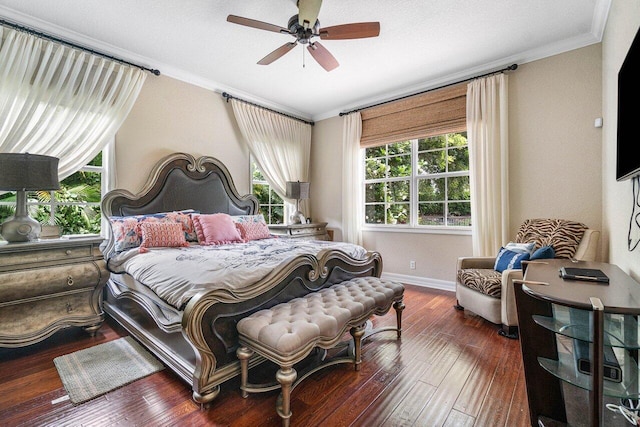 bedroom with ornamental molding, dark hardwood / wood-style floors, and ceiling fan