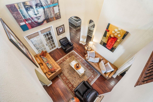 living room featuring hardwood / wood-style floors and a high ceiling