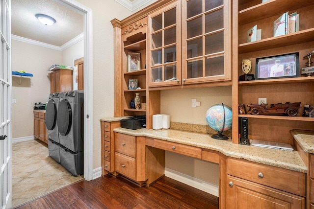 office featuring crown molding, separate washer and dryer, built in desk, a textured ceiling, and dark hardwood / wood-style floors