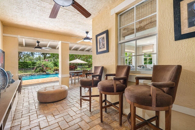 view of patio featuring a fenced in pool and ceiling fan