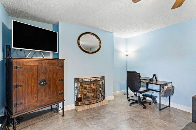 office with ceiling fan, a textured ceiling, and light tile patterned floors