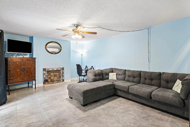 tiled living room with ceiling fan and a textured ceiling