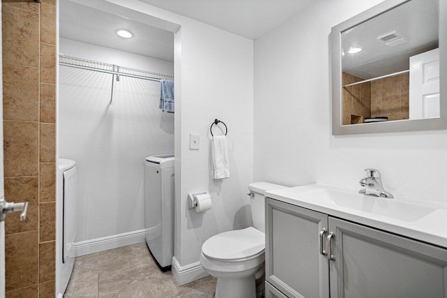 full bathroom with washer and dryer, visible vents, vanity, and toilet