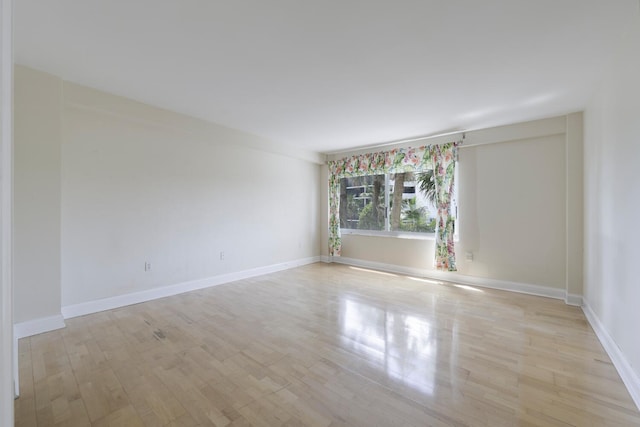 spare room featuring light wood-type flooring