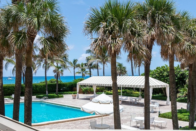 view of pool featuring a gazebo, a patio area, and a water view