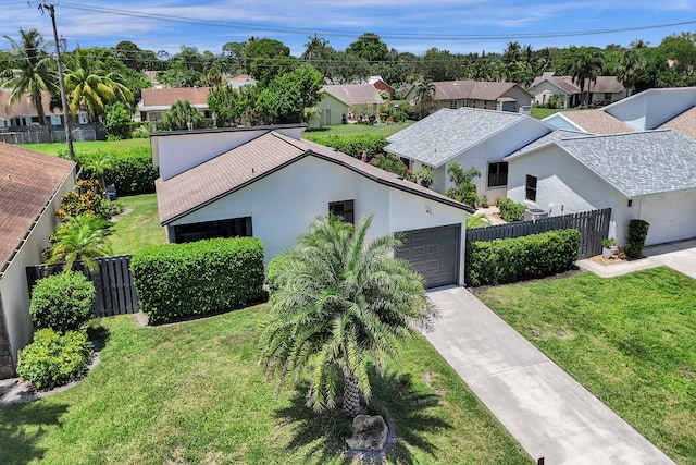 view of front of property with a garage and a front lawn