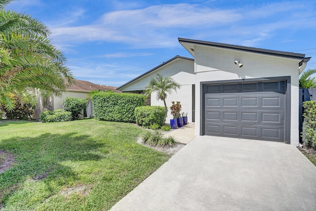 view of front of property featuring a front lawn and a garage