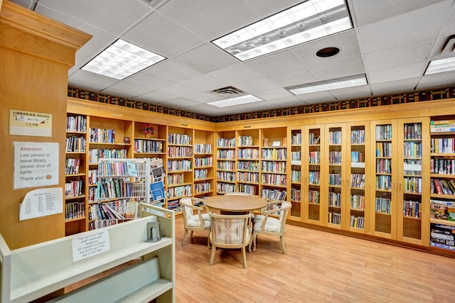 sitting room featuring light hardwood / wood-style flooring and a paneled ceiling