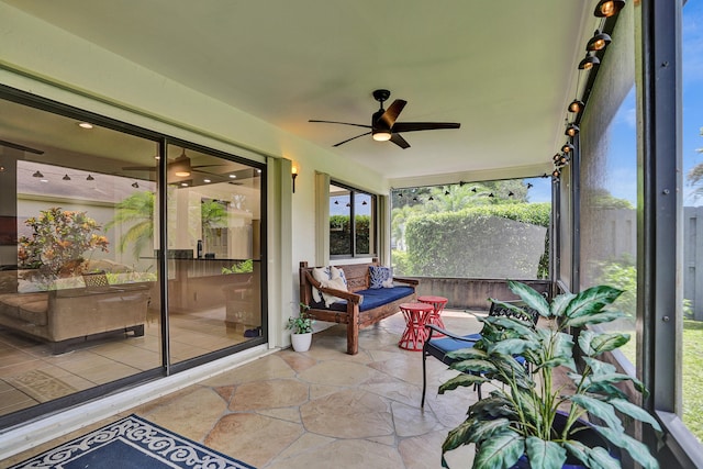 sunroom featuring ceiling fan