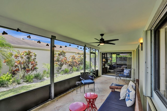 sunroom / solarium featuring ceiling fan