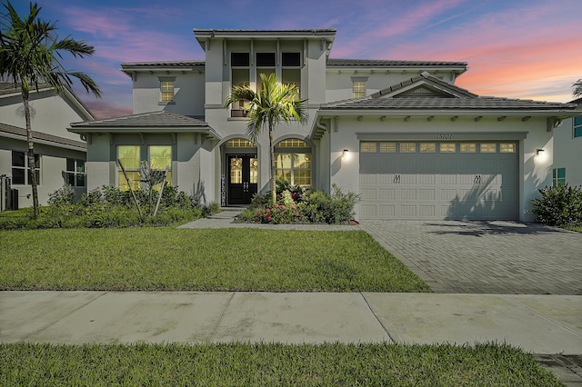 view of front of property featuring a yard and a garage