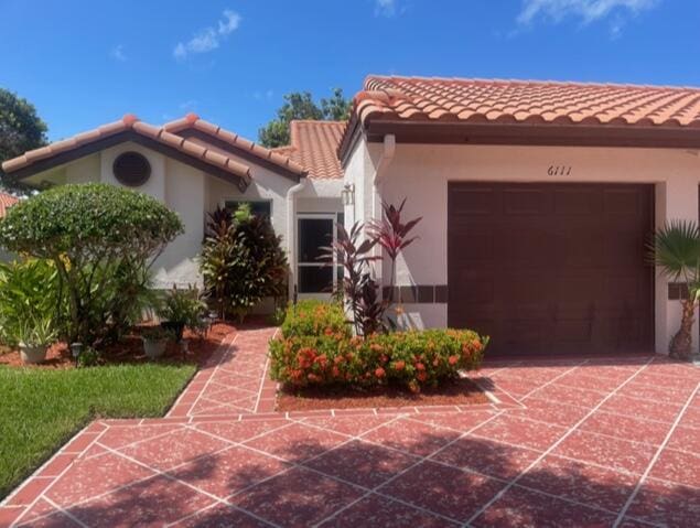 mediterranean / spanish-style home featuring a garage