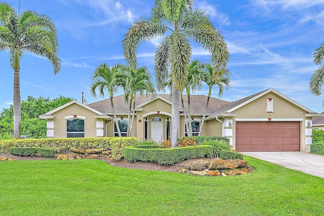 ranch-style home with a front yard and a garage