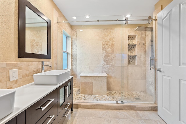 bathroom featuring tile walls, an enclosed shower, vanity, and tile patterned floors