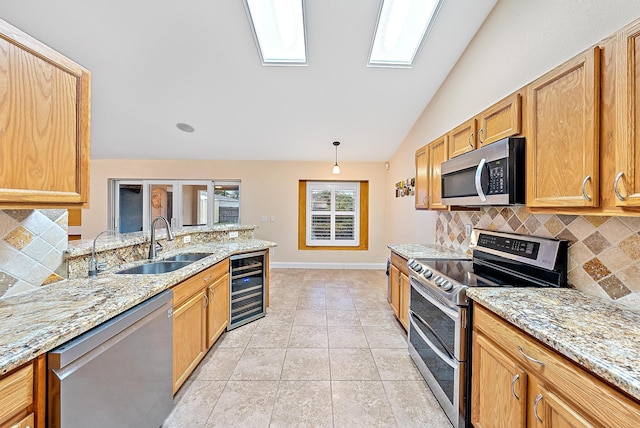 kitchen with light tile patterned flooring, appliances with stainless steel finishes, wine cooler, vaulted ceiling, and tasteful backsplash