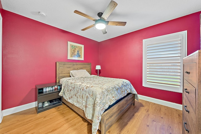 bedroom with light hardwood / wood-style flooring and ceiling fan