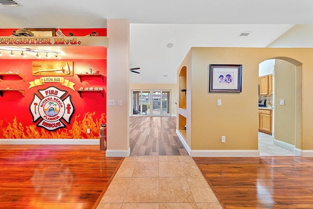 hall with tile patterned floors