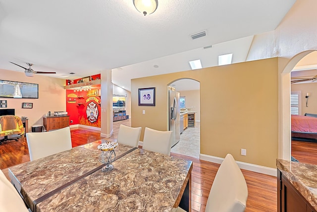 dining area with ceiling fan and light hardwood / wood-style flooring