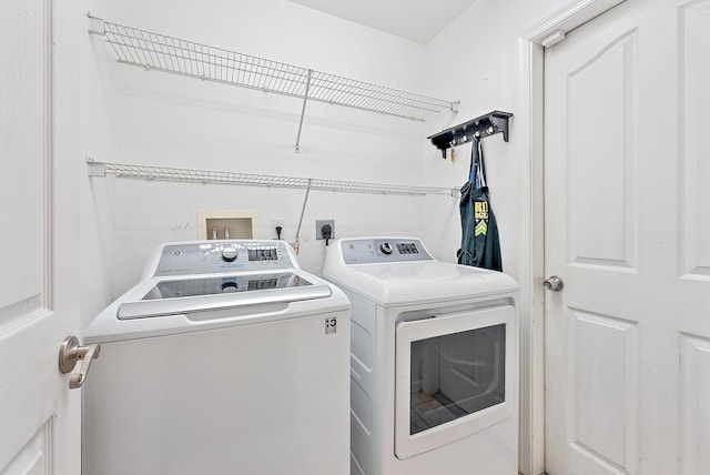 clothes washing area with washer and dryer