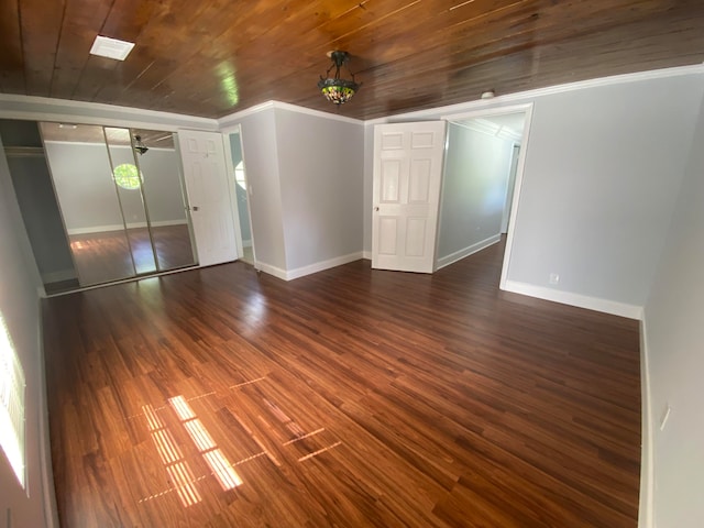 spare room with crown molding, wood ceiling, ceiling fan, and dark hardwood / wood-style floors