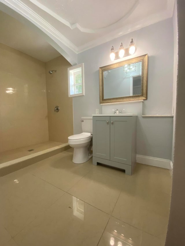 bathroom featuring tile patterned flooring, tiled shower, toilet, and ornamental molding