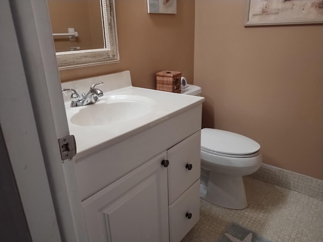 bathroom featuring vanity, toilet, and tile patterned floors