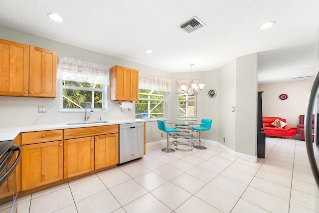 kitchen featuring stainless steel dishwasher, range, sink, an inviting chandelier, and light tile patterned flooring