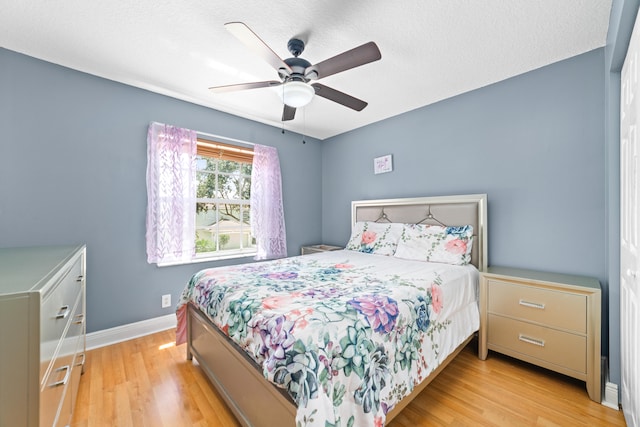 bedroom with light wood-type flooring and ceiling fan