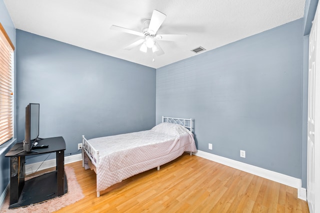 bedroom with ceiling fan and hardwood / wood-style flooring