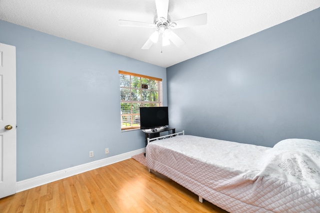 bedroom featuring ceiling fan and light hardwood / wood-style flooring