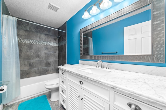 full bathroom with shower / bath combination with curtain, tile patterned floors, a textured ceiling, vanity, and toilet