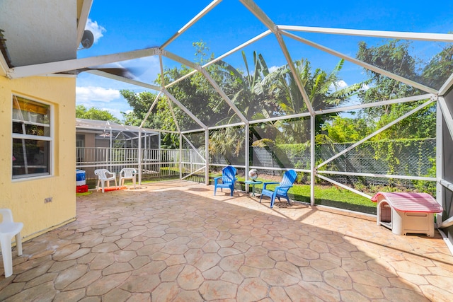 view of patio with glass enclosure