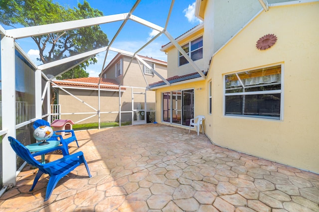 view of patio / terrace featuring glass enclosure